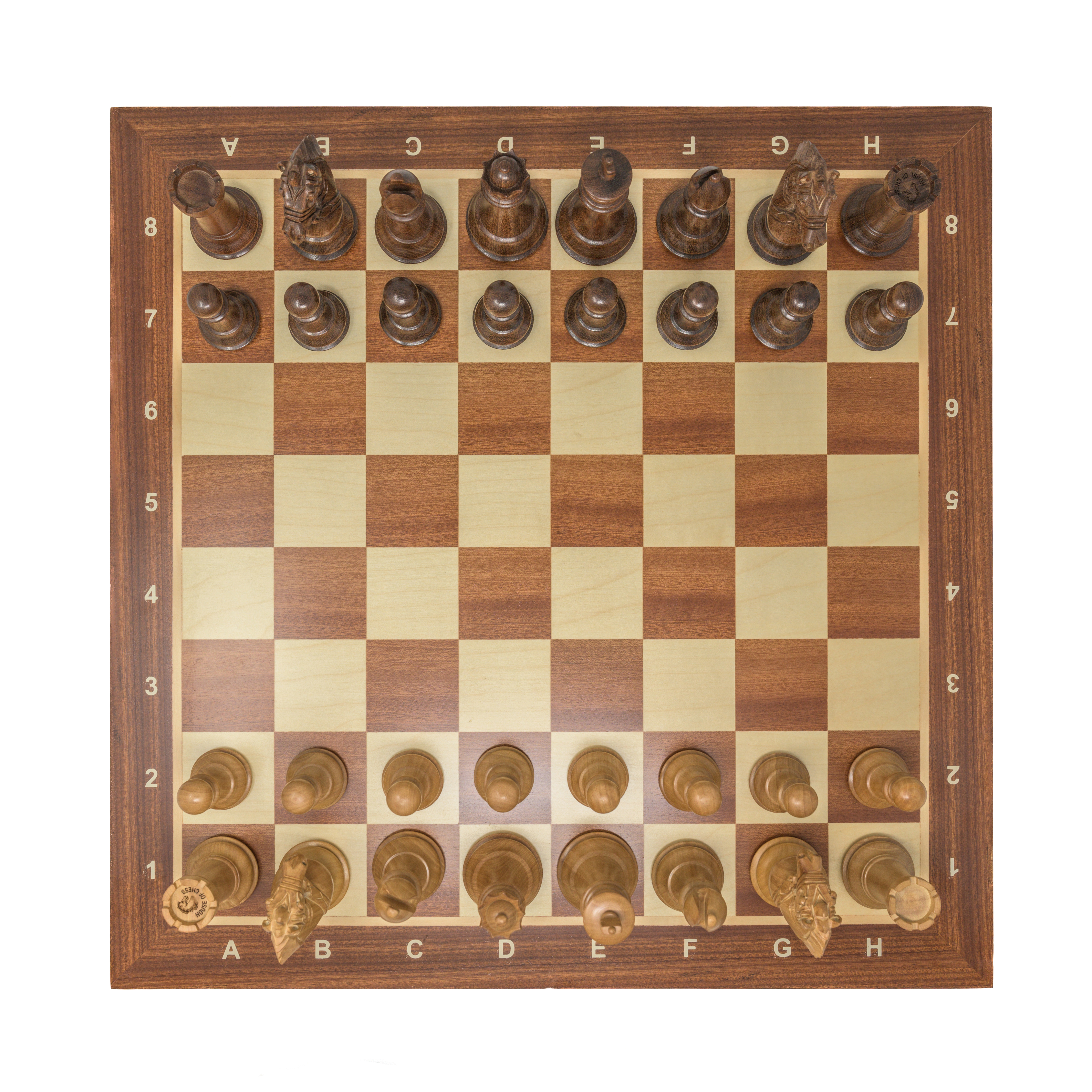Close-up of Staunton chess pieces on a green vinyl board